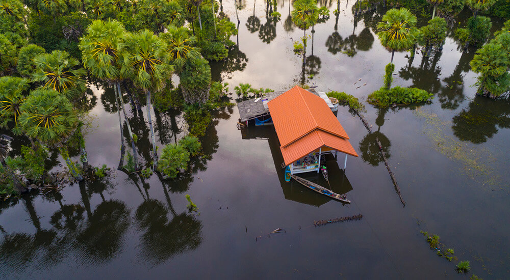Ariel view of a property surrounded by flood water.